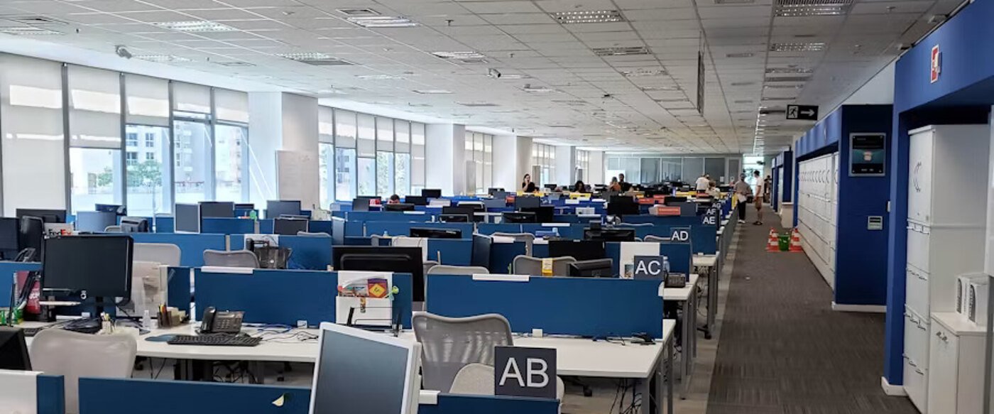 An open office floor with long rows of workstations