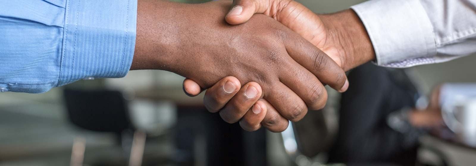 A handshake across a meeting table